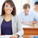 felnott-kepzes-130 Portrait of female student looking at camera at lesson on background of two group mates